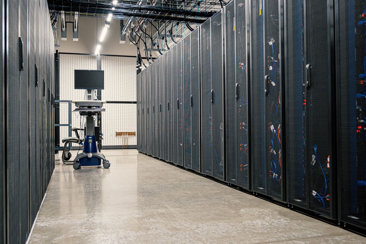 services-01 Steel framework cabinets housing servers networking devices and cables in contemporary equipped data center